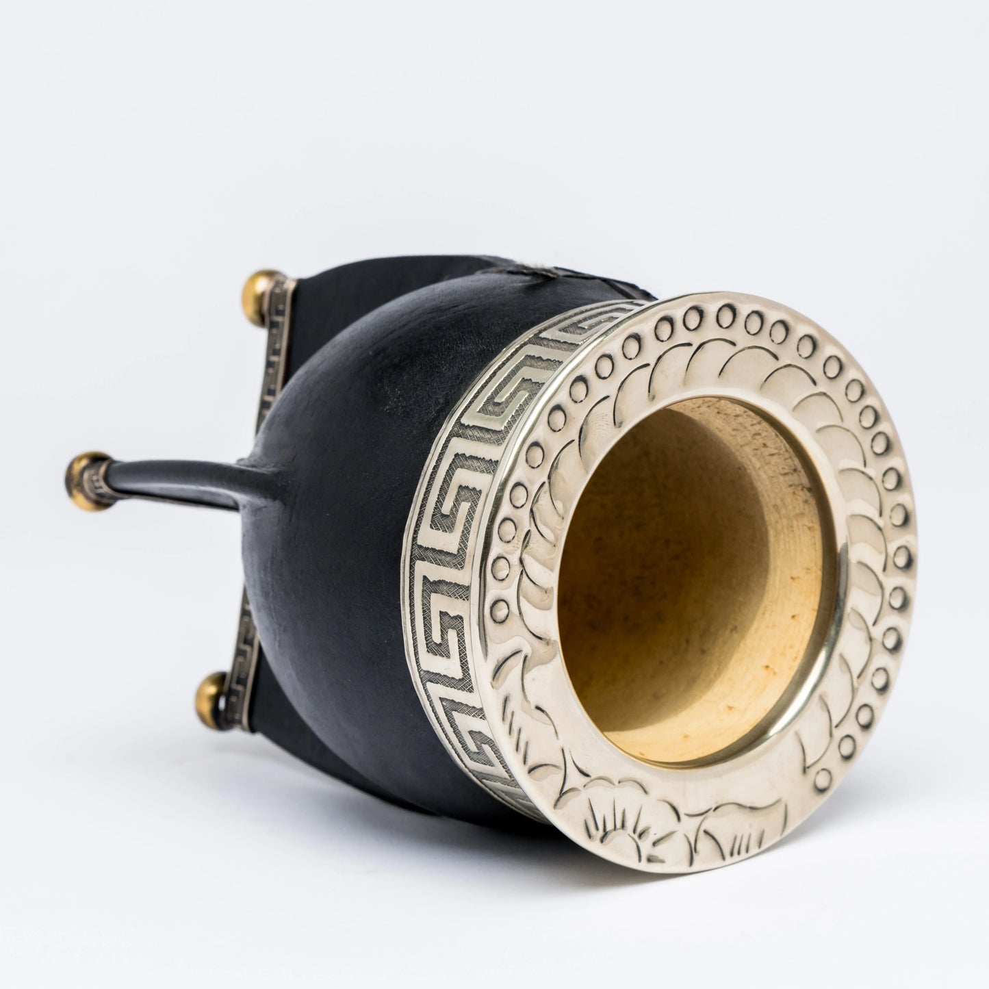 Mate gourd facing sideway to appreciate handmade design on metal