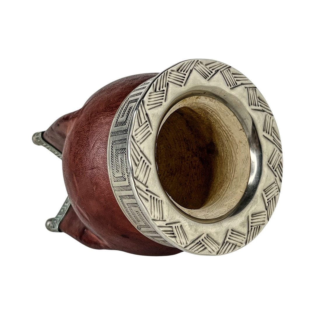 Mate gourd facing sideway to appreciate handmade design on metal